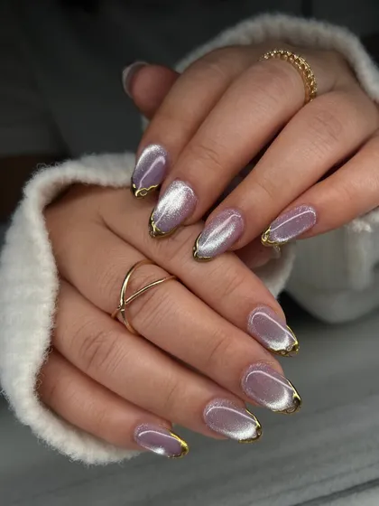 This two-hand shot shows the beautiful consistency of the lavender cat-eye and gold drip design. It's a unique way to combine two popular trends.