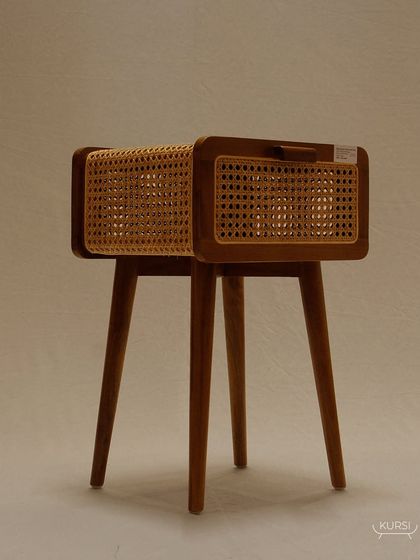 The 'Koshi' bedside table, a piece where luxury is redefined. The combination of a solid teak body and delicate rattan shutters is crafted to perfection.