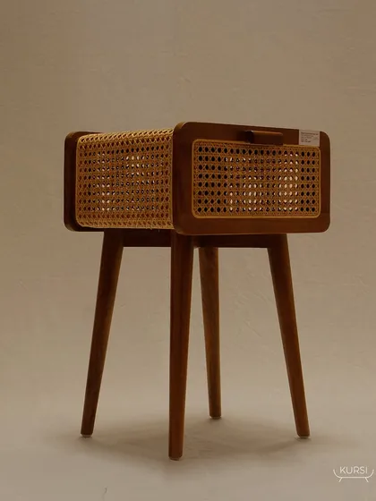 The 'Koshi' bedside table, a piece where luxury is redefined. The combination of a solid teak body and delicate rattan shutters is crafted to perfection.