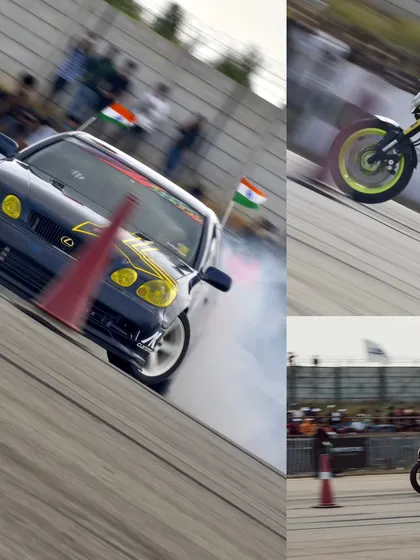 A custom Lexus drift car with Indian flags goes sideways, surrounded by smoke, while a stunt rider performs a wheelie. This is patriotism and horsepower combined.