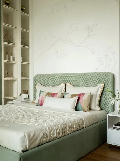Another angle of the green bedroom, highlighting the quilted headboard and the nature-inspired 3D wall mural. The mix of textures and the soothing color palette create a truly unique sanctuary.
