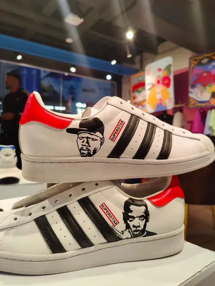 A tribute to hip-hop legends on a pair of Adidas Superstars, featuring portraits of 50 Cent and Jay-Z.