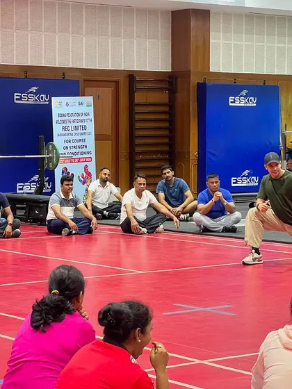 Demonstrating a lunge variation to a group of coaches. Proper form and technique are the foundation of any effective strength program.