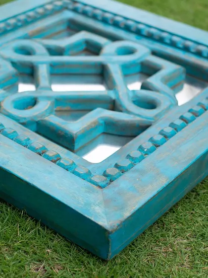 The beauty is in the details. This close-up shows the meticulous hand-carving on one of my square wooden mirrors. Each groove and bead is a testament to the artisan's skill, making every mirror a unique piece of functional art.