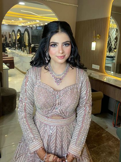 A beautiful portrait of this engagement bride. The makeup is flawless, and her hair is styled in a chic half-updo.