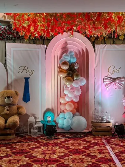This teddy bear themed baby shower stage is perfect for a gender reveal party. It features 'Boy' and 'Girl' panels, large teddy bears, and a mix of blue and pink balloons, creating a sweet and playful atmosphere.