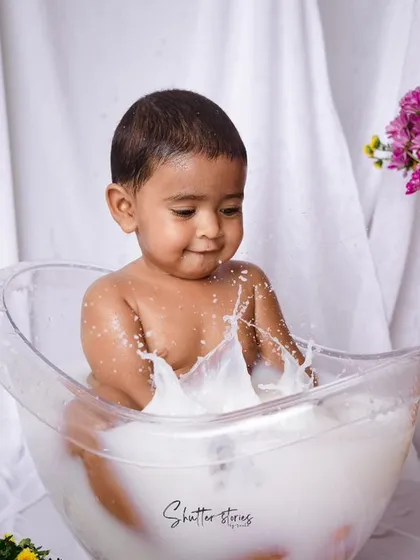 Splash time! After the cake smash, a milk bath is the perfect way to clean up and capture some more adorable, playful moments.