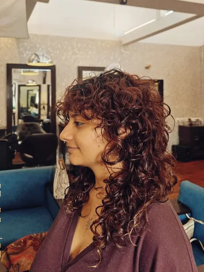 I have a special love for curly hair. This tailored cut was designed to enhance the natural curl pattern, creating beautiful definition and bounce without sacrificing length.