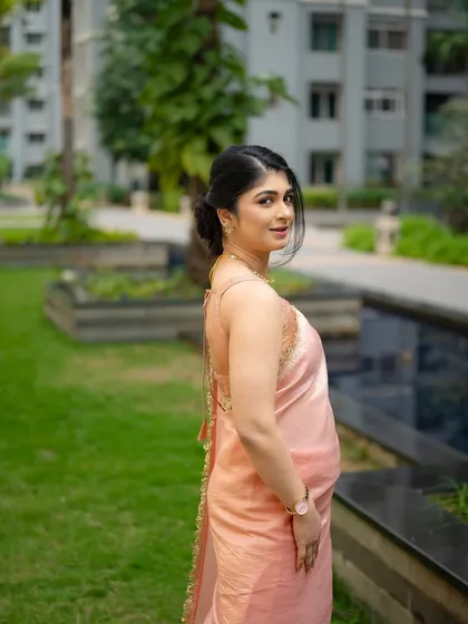 A candid portrait of actress Aditi Prabhudeva looking over her shoulder. The soft lighting and natural background create a simple and elegant shot.