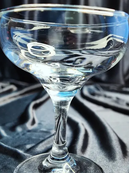 This is a coupe glass, a vintage-style option for serving champagne or cocktails like the Gimlet or Daiquiri.