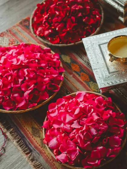 Baskets of fresh rose petals ready for the Haldi ceremony. We believe in using natural, beautiful elements in our rituals.