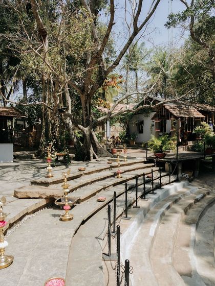 The stone steps of the Kalyani decorated with traditional brass lamps, ready for an evening ceremony.