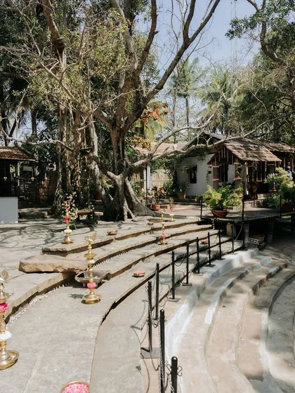 The stone steps of the amphitheater, lined with traditional brass lamps, create a beautiful pathway for a ceremony.