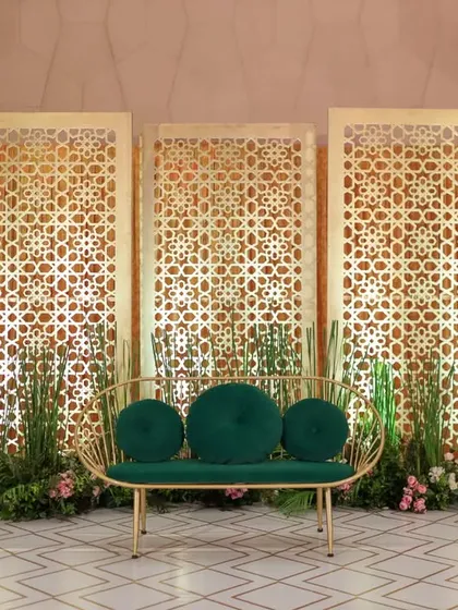 This stage design combines modern elegance with intricate details. The gold latticework panels and deep green accents create a sophisticated backdrop suitable for a VIP lounge, panel discussion, or an exclusive corporate dinner.