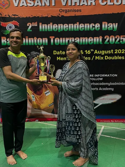 A D-Group Men's Doubles runner-up receiving his trophy.