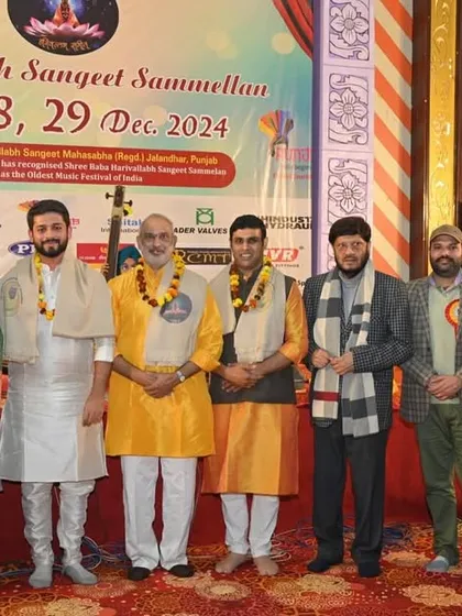 A group photo with fellow artists and organizers at the Shree Baba Harivallabh Sangeet Sammelan in Jalandhar, Punjab.