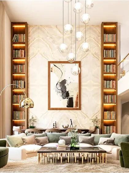 We specialize in designing for unique architectural features like double-height living rooms. Here, we used towering built-in bookshelves, a cascading chandelier, and curated furniture to accentuate the room's scale and create a grand, library-like ambiance.