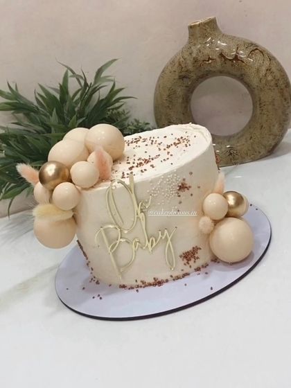 This view shows the delicate texture and sprinkle details on the "Oh Baby" cake.