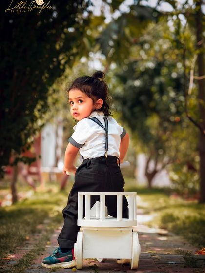 A little adventurer on his tricycle. Outdoor locations provide endless opportunities for dynamic and playful photos.