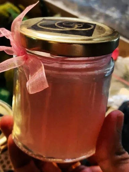 Here is a finished custom order, ready to be shipped! This is a pink scented candle in one of my classic glass jars with a golden lid, tied with a ribbon. I can create candles in any color you like to match your decor or event theme.