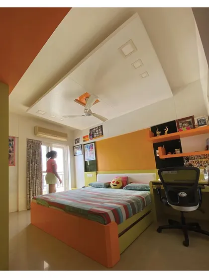 A full view of the room, showing the bed with built-in storage and a dedicated study desk, demonstrating our approach to designing multi-functional spaces for kids.