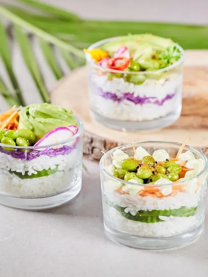 A trio of our signature Sushi Cups. This image showcases the variety and beautiful presentation of our deconstructed sushi, perfect for any grazing table.