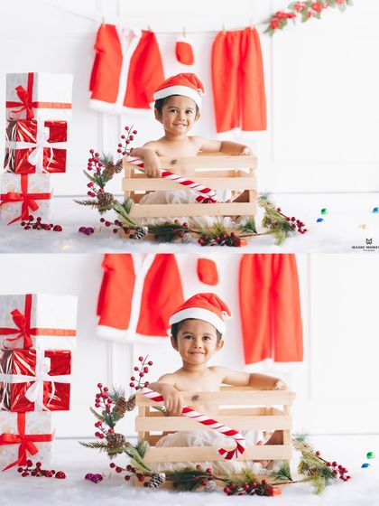 A cheerful portrait from our holiday-themed shoot. The setup includes a stack of presents and a miniature Santa suit, creating a clean and festive look for this little boy's photo.