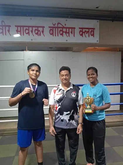Back at the club with my medal-winning boxers from the Youth Women State Championship. We bring the trophies and medals back to our akhada.