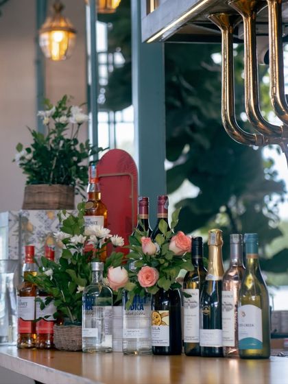The bar, beautifully decorated with flowers and showcasing a selection of premium spirits. We can create a stunning bar setup for your event, tailored to your preferences.