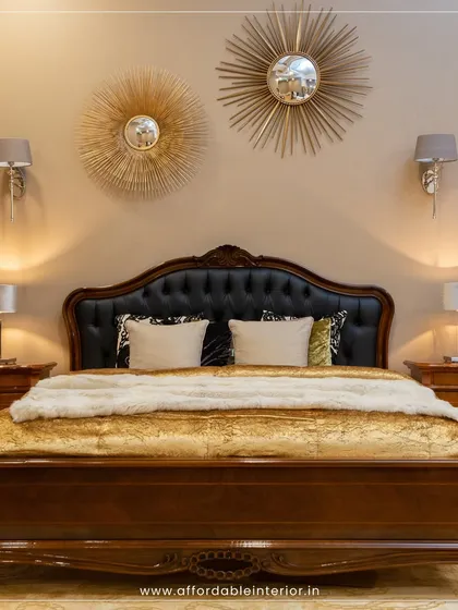 A classic bedroom design featuring a carved wooden bed with a leather headboard, ornate sunburst mirrors, and traditional bedside lamps for a touch of old-world royalty.
