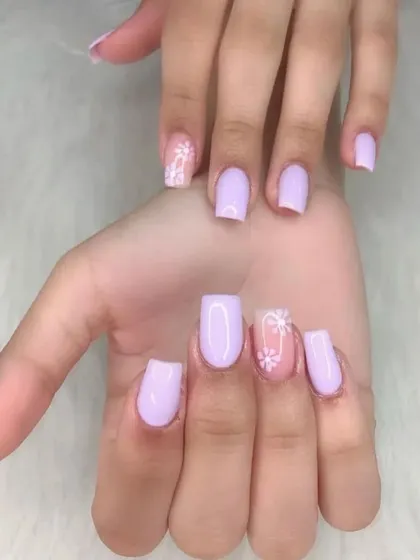 A sweet and simple design with soft lavender polish and delicate white daisy art on the accent nails.