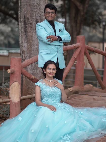 A picture of serenity. This light blue ball gown, adorned with delicate 3D flowers, creates a soft and romantic look for this couple's photoshoot on a rustic wooden bridge.