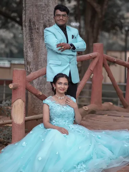 A picture of serenity. This light blue ball gown, adorned with delicate 3D flowers, creates a soft and romantic look for this couple's photoshoot on a rustic wooden bridge.