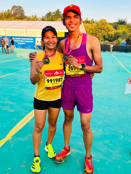 A duplicate of image 53. Posing with a fellow runner after the TCS10K. The camaraderie and shared experience of race day is a huge part of what makes the running community so special.