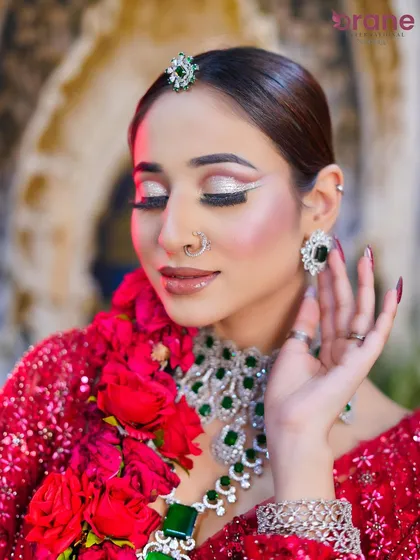 A detailed close-up of the eye makeup, showcasing the sharp, white graphic liner and shimmering silver eyeshadow.