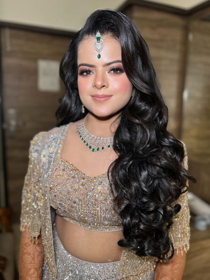 A close-up of this beautiful engagement look. The makeup is flawless, and the maang tikka adds a traditional touch.