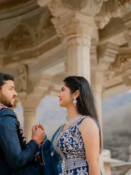 A tender moment of connection, with the intricate marble carvings of the palace providing a beautiful textured background. This candid couple photo feels both personal and grand.
