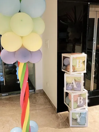 Fun decorative elements like these "BABY" blocks filled with balloons add a playful and stylish touch to any party, especially for first birthdays or baby showers.