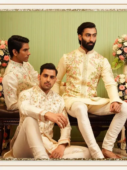 A group of models showcases our elegant, embroidered kurta and jacket sets in soft ivory tones. This image highlights our ability to create a cohesive and stylish look for any festive group.