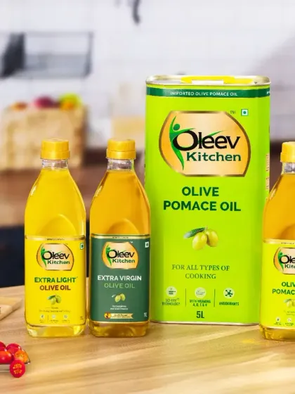 A full product family shot for a cooking oil brand, styled in a warm and inviting kitchen setting. We included fresh bread and olives to place the products in a realistic, appealing context, showing how they fit into a customer's home.