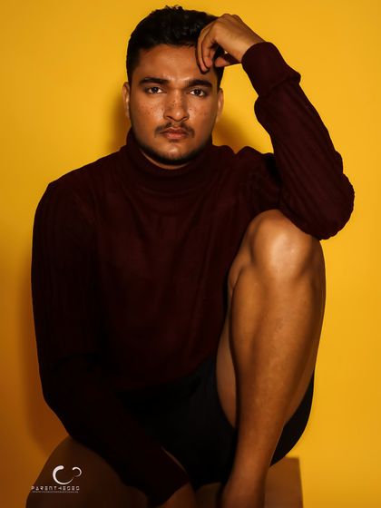 A thoughtful and introspective pose. The composition is balanced and calm, offering a moment of quiet amidst the bold color.