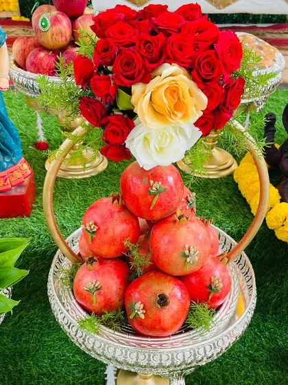 Fresh fruits and flowers bring so much life to a celebration. Here is an example of an artfully arranged fruit basket with pomegranates and fresh roses, designed to be both a beautiful centerpiece and a blessed offering.