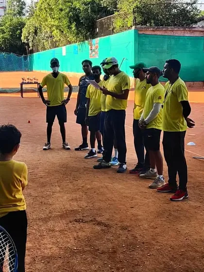 Coaches briefing the youngest group of players before a drill. Clear communication and fun are key to keeping them engaged.