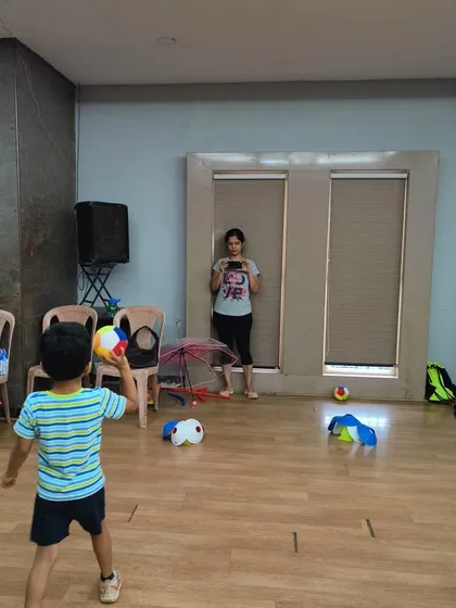 Here's another young athlete focused on his throw. Even simple games like this are packed with learning. They help children understand force, trajectory, and how to coordinate their body for a successful throw.