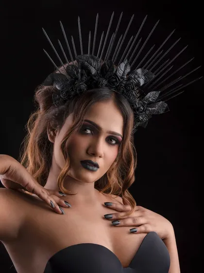 Creating a dark fantasy character with a dramatic black crown and intense makeup. The look features a deep smokey eye and bold black lipstick, perfect for a conceptual photoshoot or character transformation.