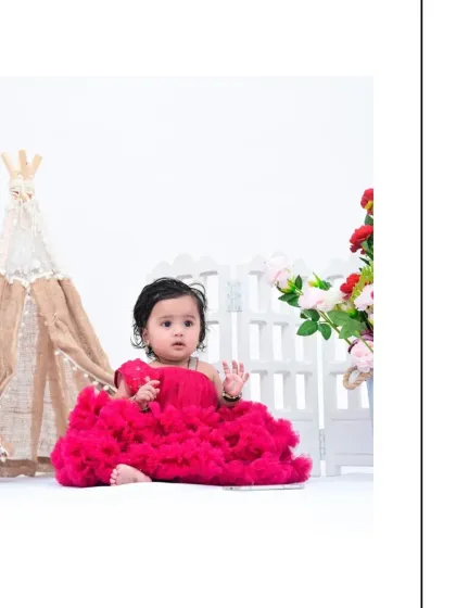 Another simple and elegant portrait against a white backdrop. The baby's curious gaze and the simplicity of the scene create a timeless and beautiful image.
