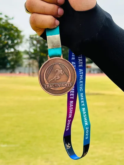 A close-up of a TrackNights medal. We believe hard work deserves recognition, and these medals symbolize the commitment and determination of every athlete who competes.