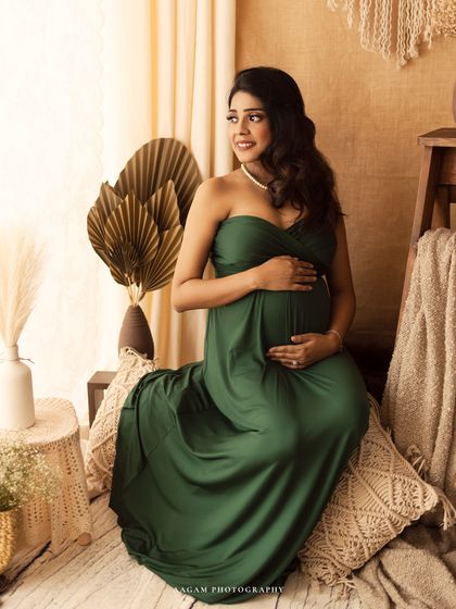 This strapless green gown looks stunning in the boho setup, with its earthy tones complementing the natural decor.