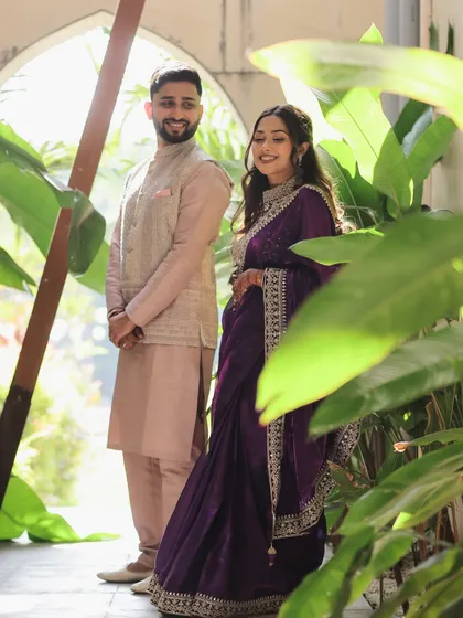 A candid moment captured between Devanshi and Anshul before their ceremony. Framed by lush greenery, this photo shows a quiet, stolen moment of connection away from the crowds.