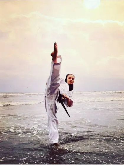Martial arts is a way of life that you carry with you everywhere. A student practices her form by the sea, showing that the discipline and focus learned in the dojo become a part of who you are, bringing balance and strength to your life.